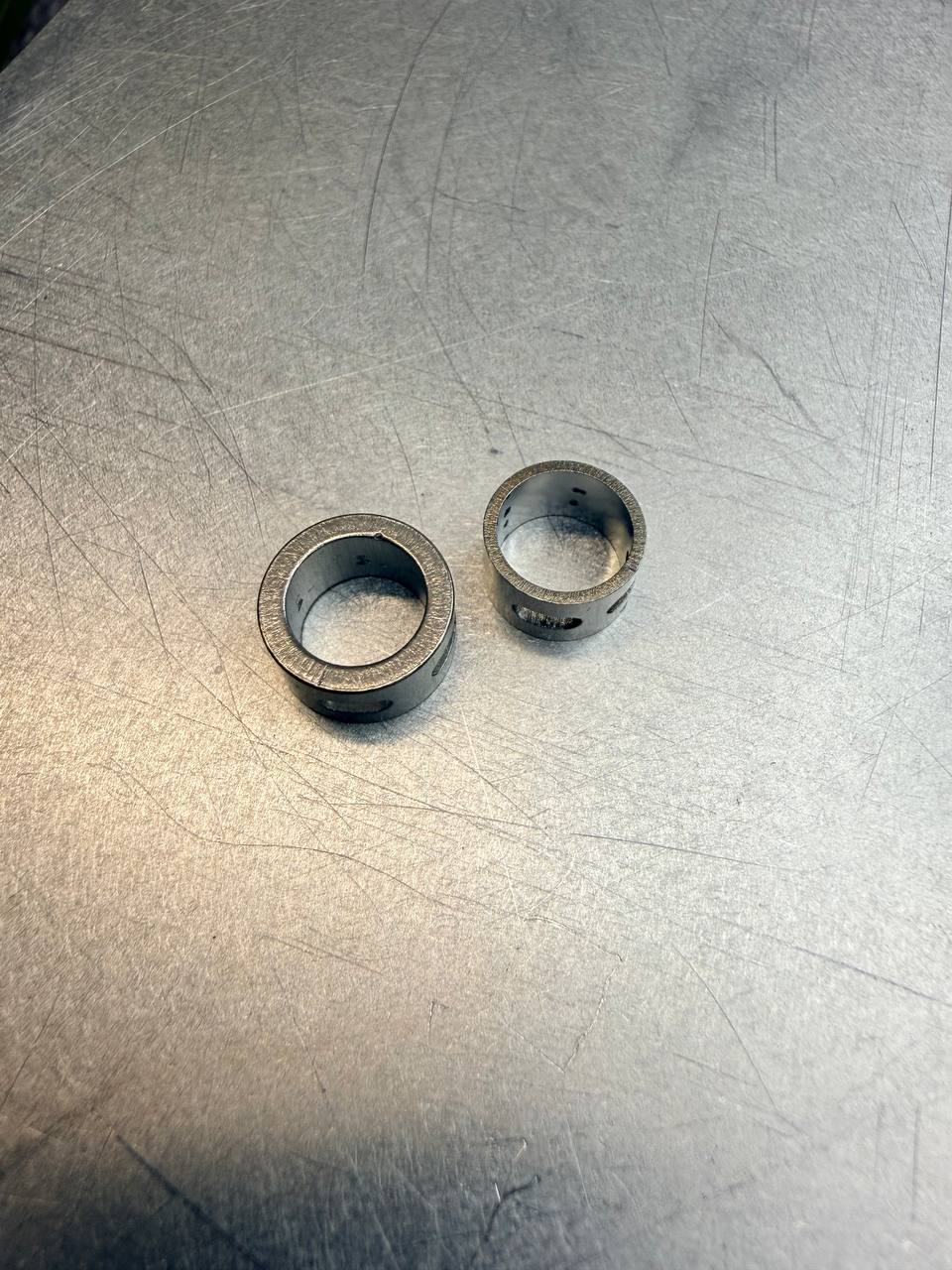 Two stainless-steel Wacky-Neko Rings in different sizes side by side